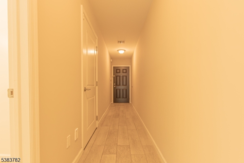 246 James Street Hackensack, NJ 07601 - Photo 3 of 23 a view of a hallway with wooden floor