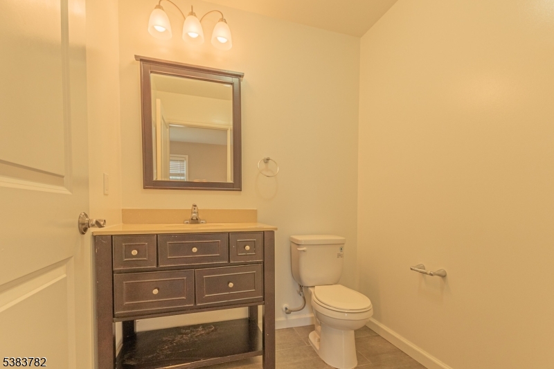 246 James Street Hackensack, NJ 07601 - Photo 7 of 23 a bathroom with a granite countertop toilet sink and mirror