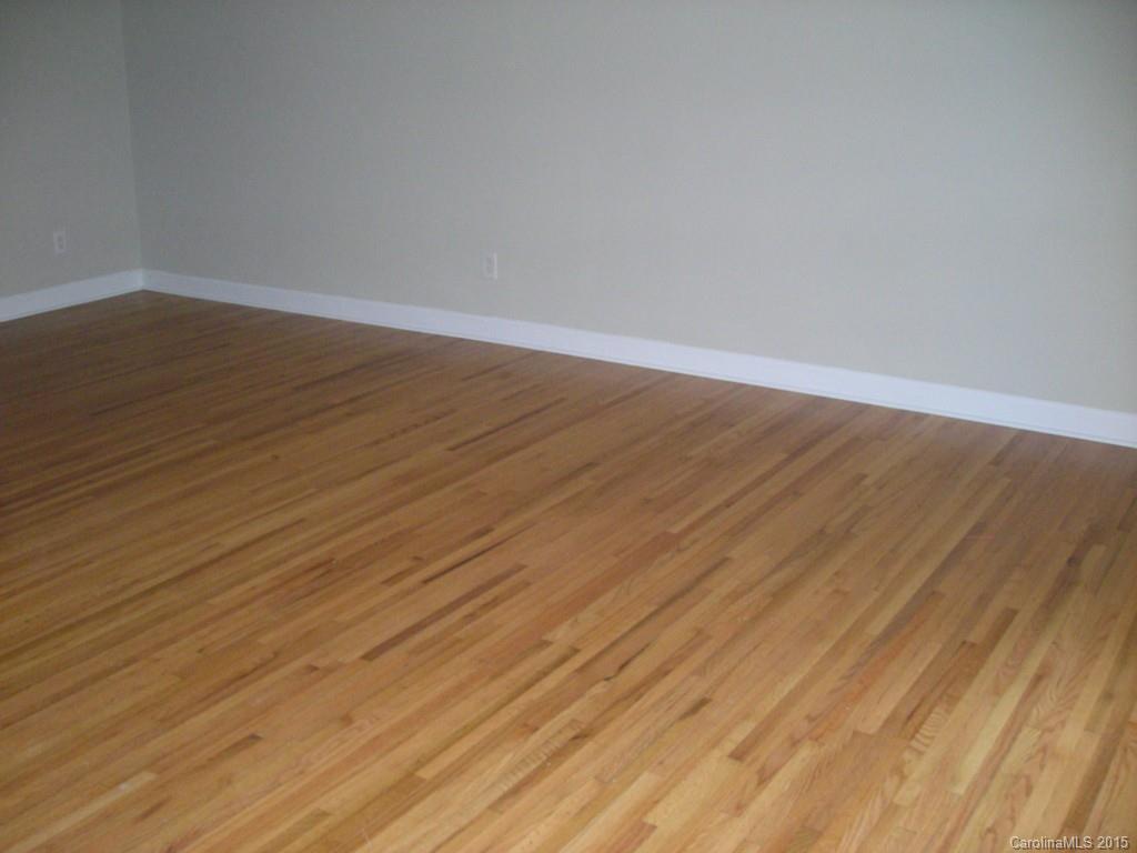 4701 Fairheath Road, Unit 23 Charlotte, NC 28210 - Photo 2 of 5 a view of an empty room with wooden floor