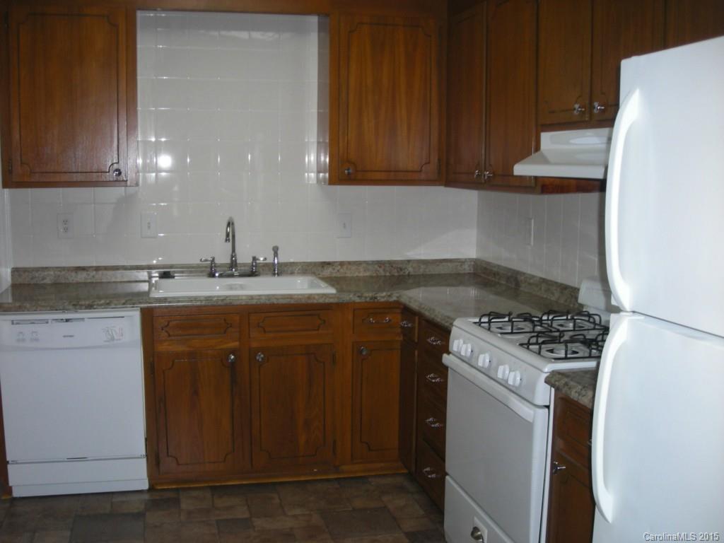 4701 Fairheath Road, Unit 23 Charlotte, NC 28210 - Photo 3 of 5 a kitchen with a sink a stove and cabinets