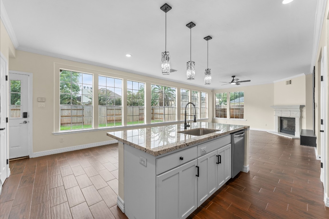 6330 Borg Breakpoint Drive Spring, TX 77379 - Photo 15 of 49 a hall with kitchen island granite countertop a sink and a large window