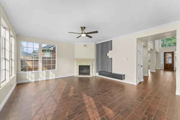 a view of an empty room with a fireplace and a window