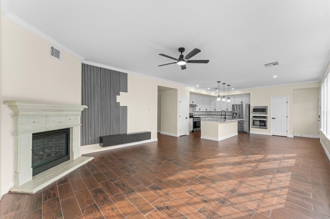 6330 Borg Breakpoint Drive Spring, TX 77379 - Photo 17 of 49 a view of an empty room with kitchen and fireplace