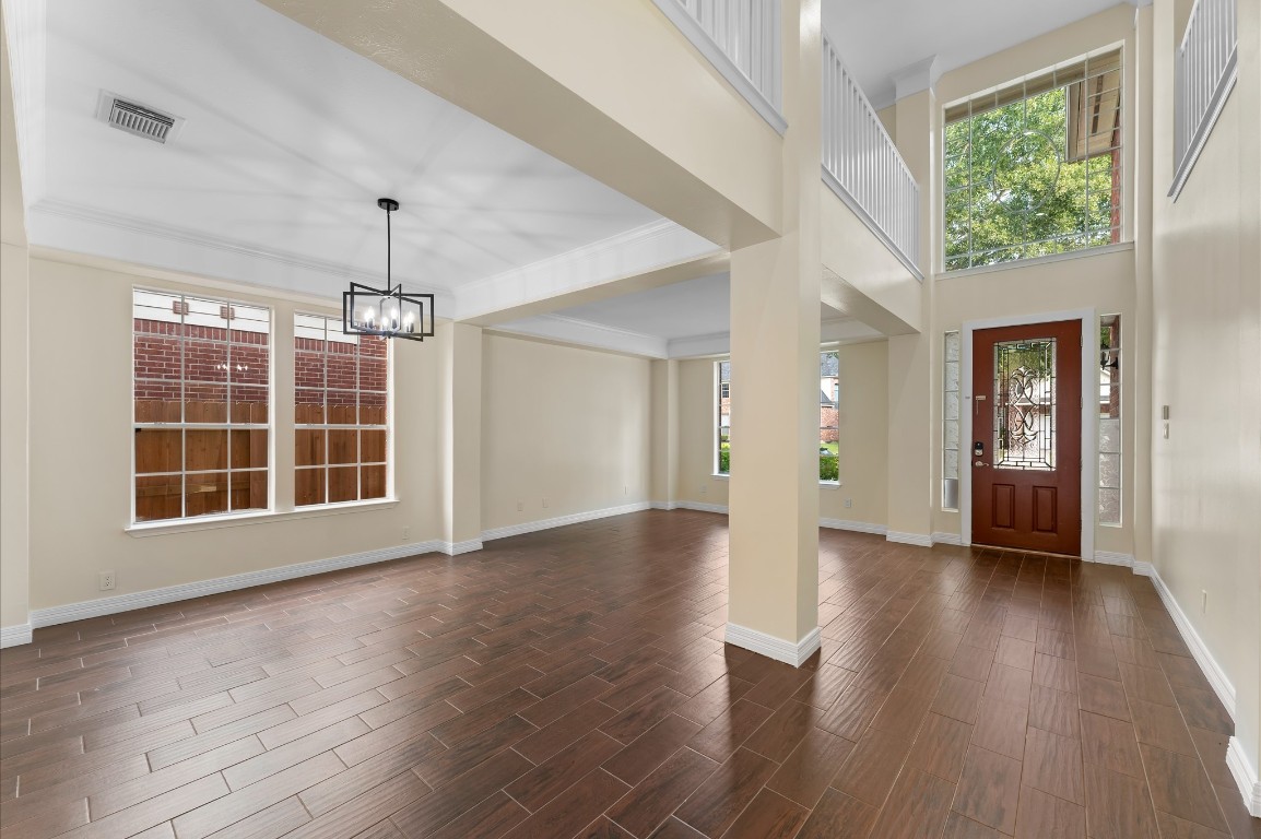 6330 Borg Breakpoint Drive Spring, TX 77379 - Photo 6 of 49 a view of an empty room with wooden floor and a window