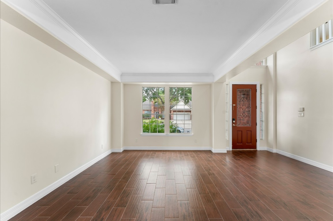 6330 Borg Breakpoint Drive Spring, TX 77379 - Photo 8 of 49 an empty room with wooden floor and windows