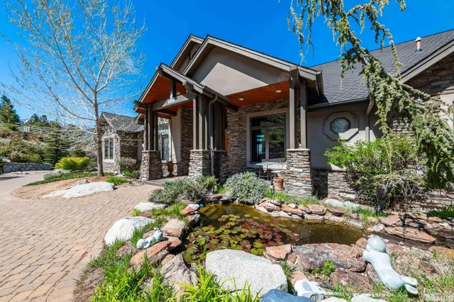 a view of a house with potted plants