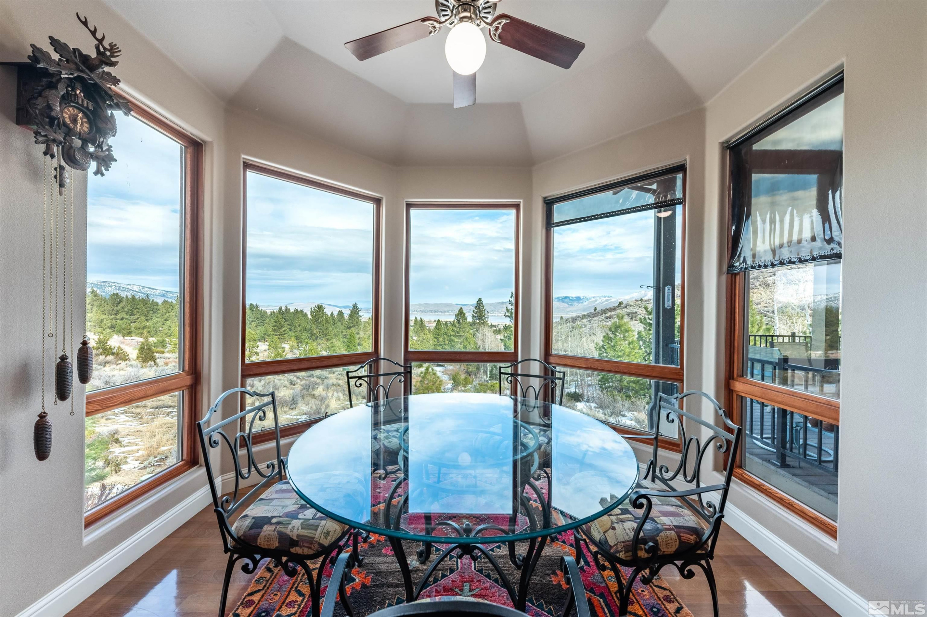 7450 Bryan Canyon Road Washoe Valley, NV 89704 - Photo 11 of 34 a view of a dining room with furniture large windows and wooden floor