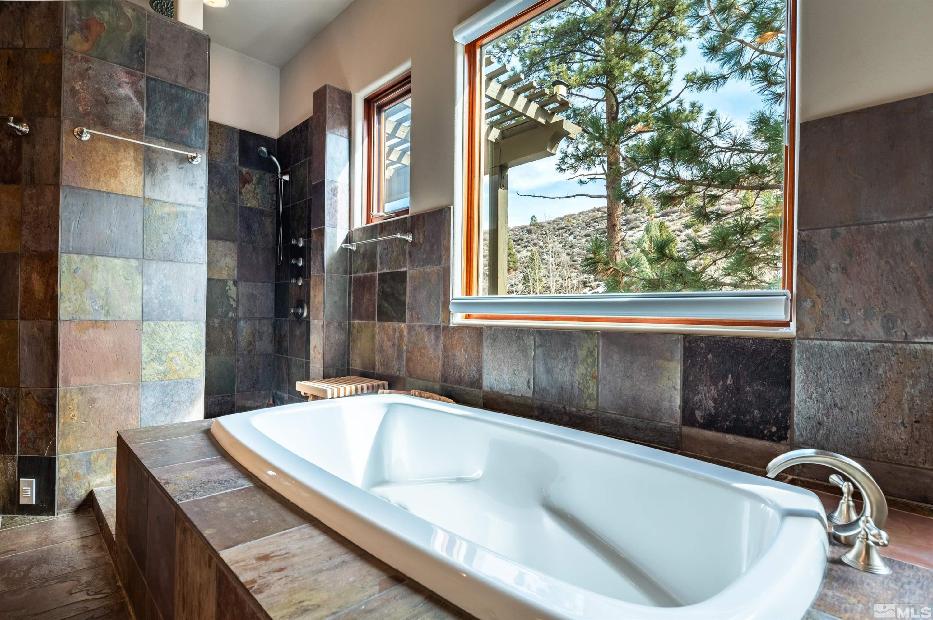 7450 Bryan Canyon Road Washoe Valley, NV 89704 - Photo 14 of 34 a bath tub sitting in a bathroom next to a window