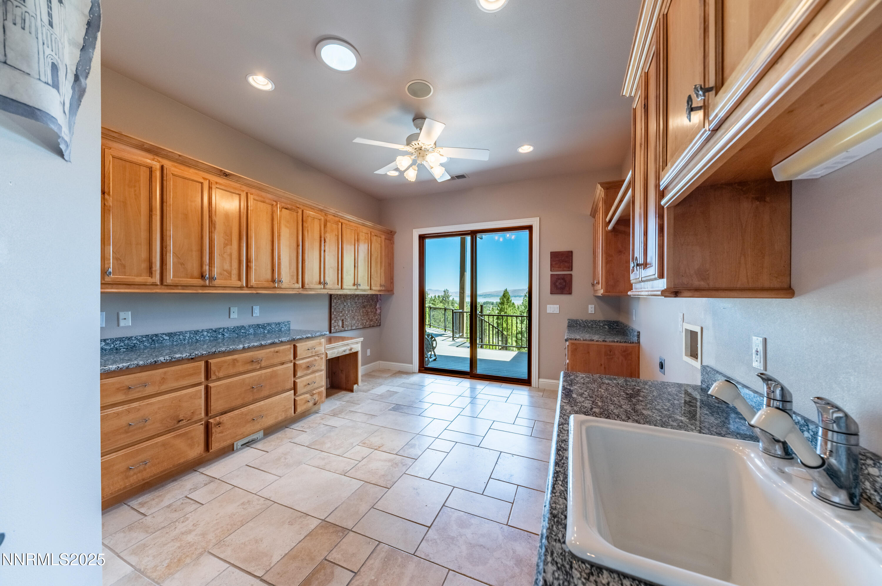 7450 Bryan Canyon Road Washoe Valley, NV 89704 - Photo 15 of 34 a kitchen with granite countertop a sink cabinets and window