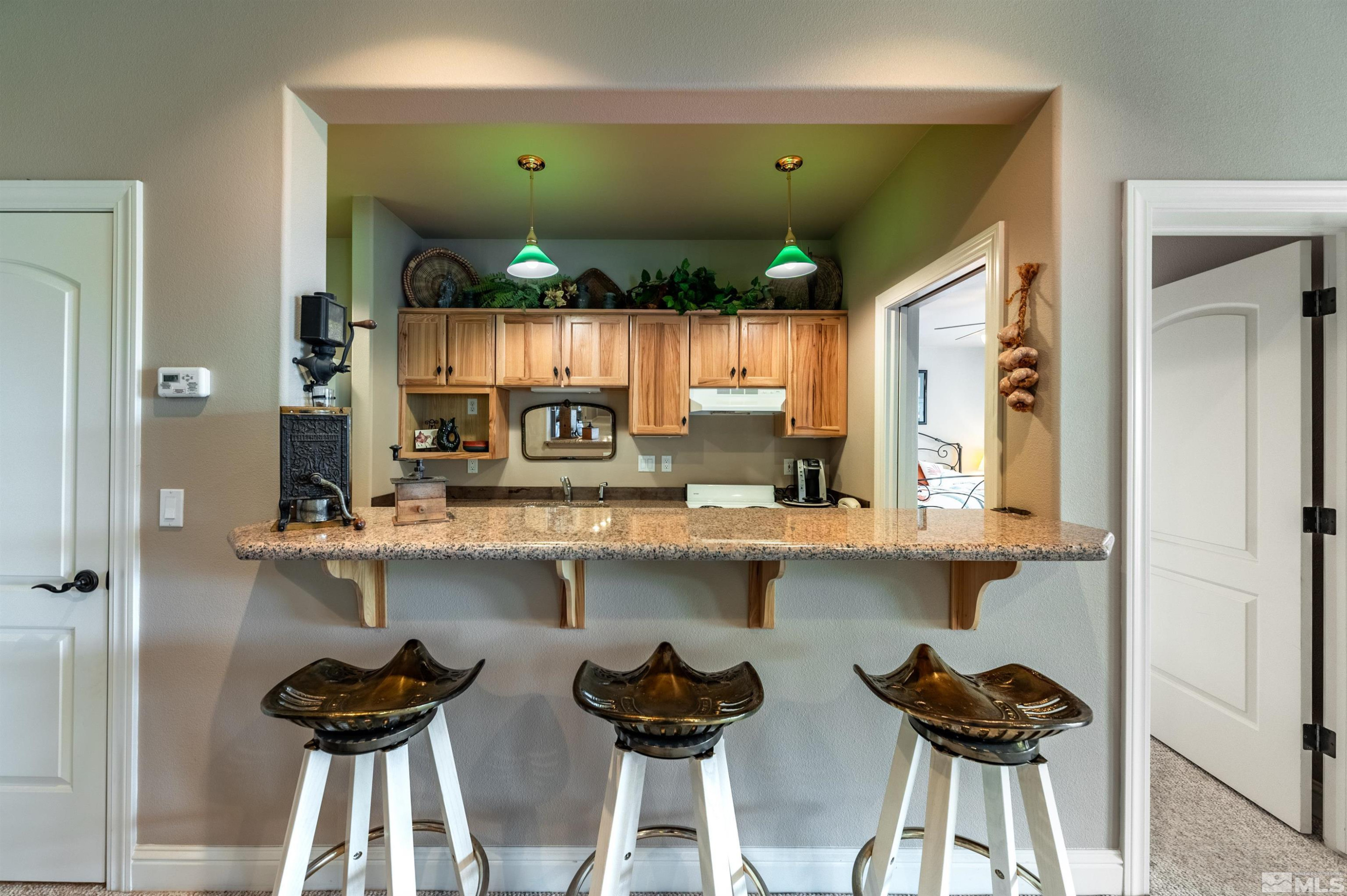 7450 Bryan Canyon Road Washoe Valley, NV 89704 - Photo 17 of 34 a kitchen with stainless steel appliances kitchen island a sink and cabinets