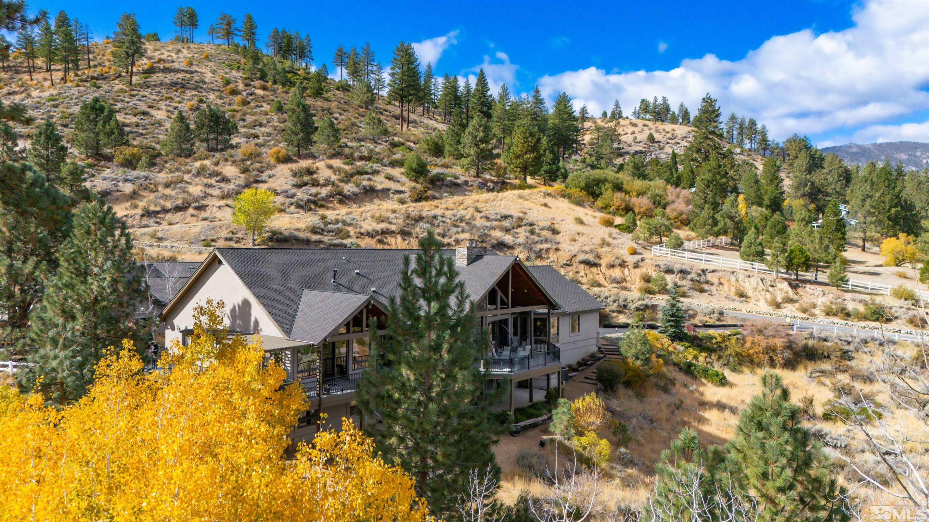 7450 Bryan Canyon Road Washoe Valley, NV 89704 - Photo 21 of 34 a view of residential houses with yard and swimming pool