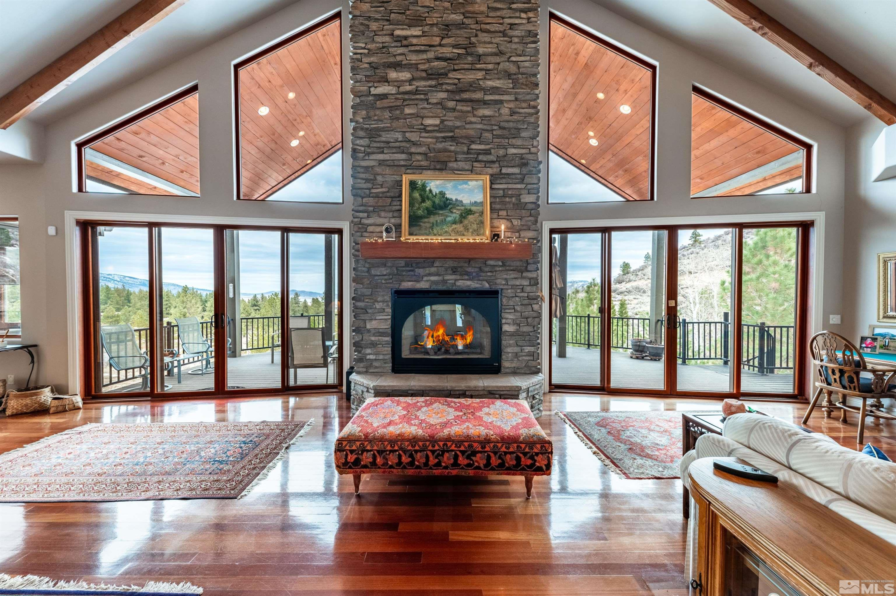 7450 Bryan Canyon Road Washoe Valley, NV 89704 - Photo 5 of 34 a living room with furniture and a fireplace