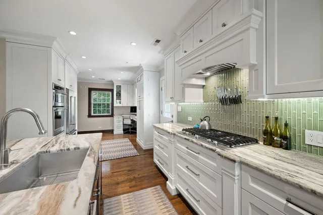 a kitchen with sink stove and cabinets