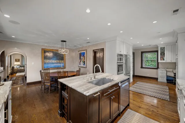 a living room with stainless steel appliances granite countertop furniture and a kitchen view