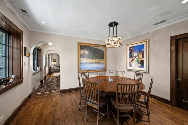 a view of a dining room with furniture wooden floor and chandelier