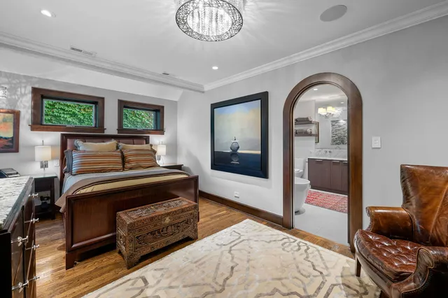 a bedroom with furniture and a mirror