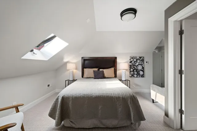 a bedroom with a bed and window