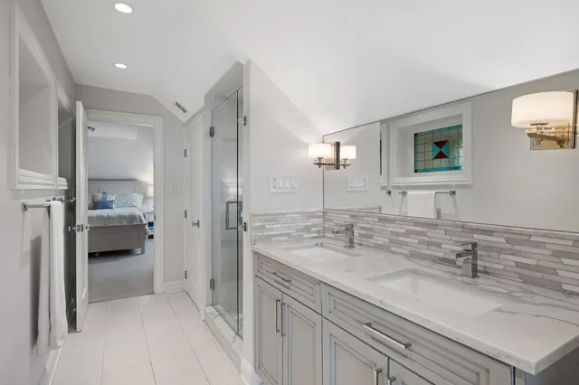 a en suite bathroom with a sink a mirror and a shower