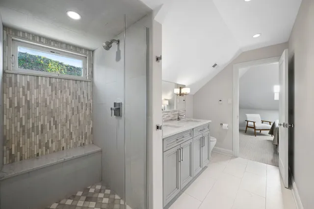 a large bathroom with a double vanity sink and a mirror