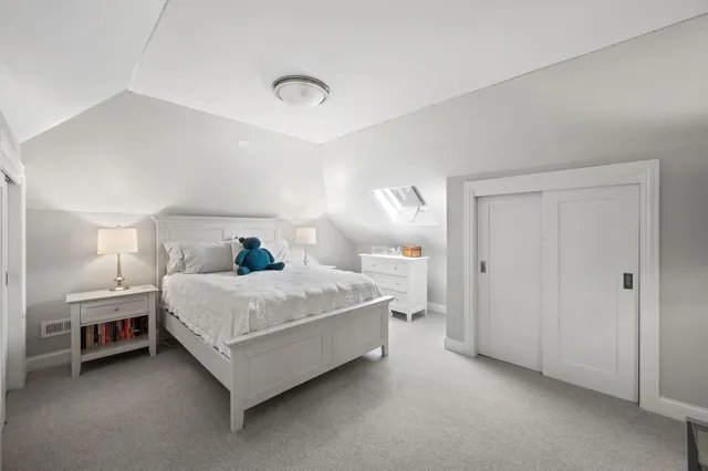 a bedroom with a bed and a night stand