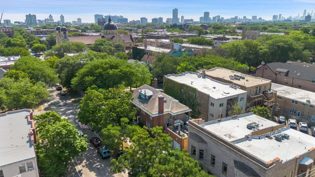an aerial view of a houses with a city view