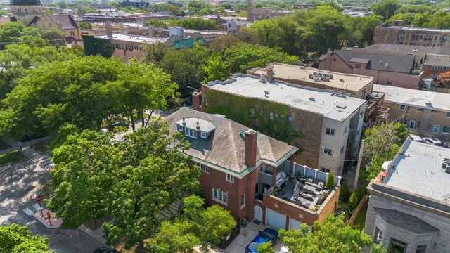 an aerial view of a house with garden space and a street view