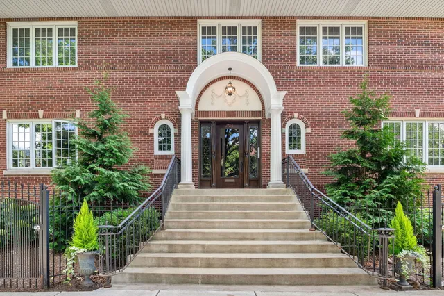 a view of a brick building with potted plants