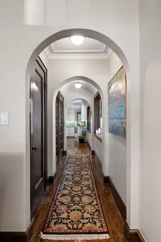 a view of a hallway with wooden floor