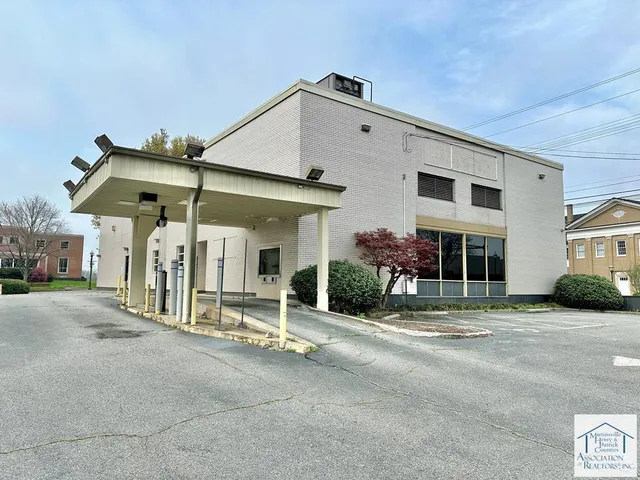 a patio with a table and chairs under an umbrella