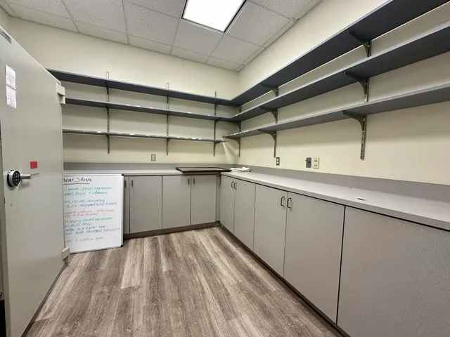 a kitchen with stainless steel appliances granite countertop a refrigerator a sink dishwasher and a stove with wooden floor