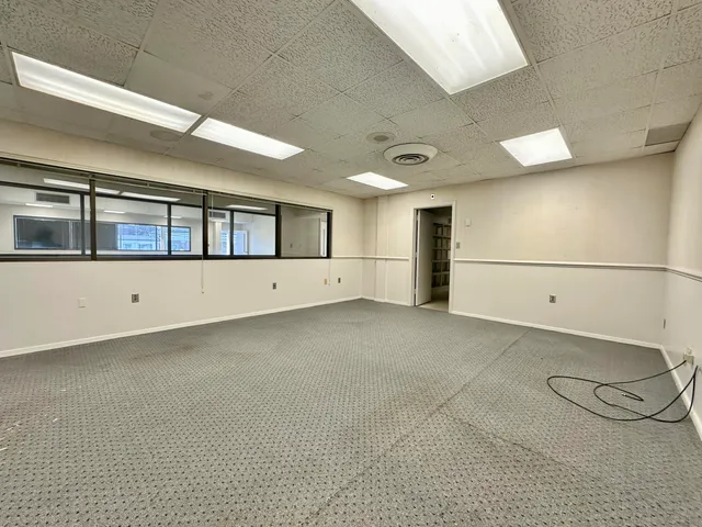 a view of an empty room with a fireplace