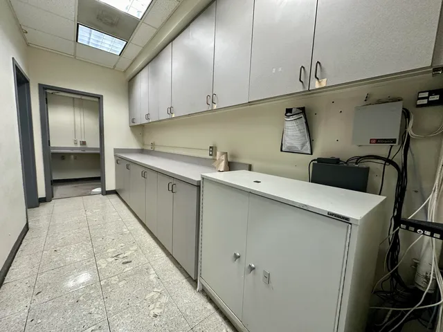a spacious bathroom with a granite countertop sink and a mirror