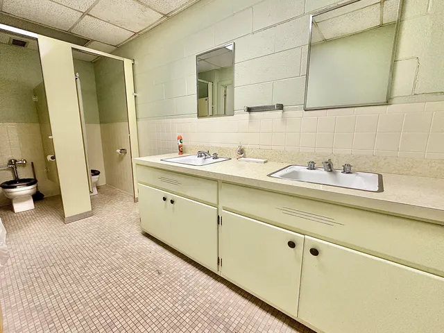 a room with lot of large windows and a table