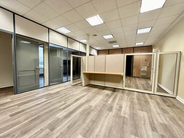 a view of an empty room with wooden floor
