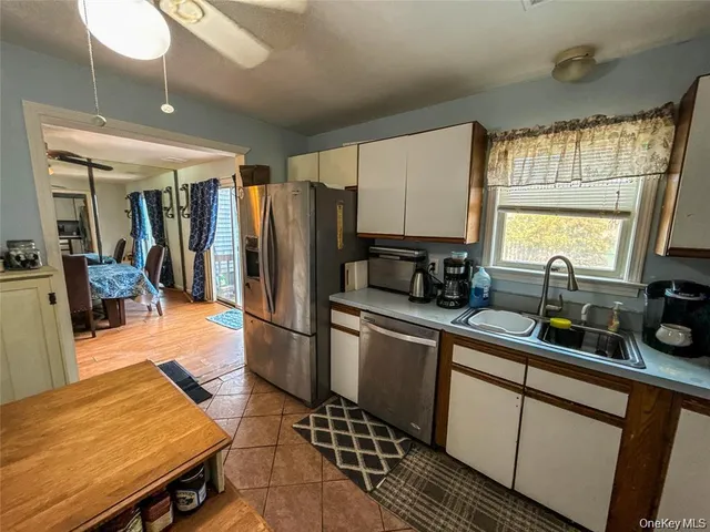 a kitchen with stainless steel appliances granite countertop a refrigerator and sink