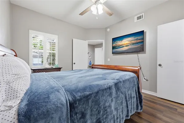 a bedroom with a bed and a flat screen tv