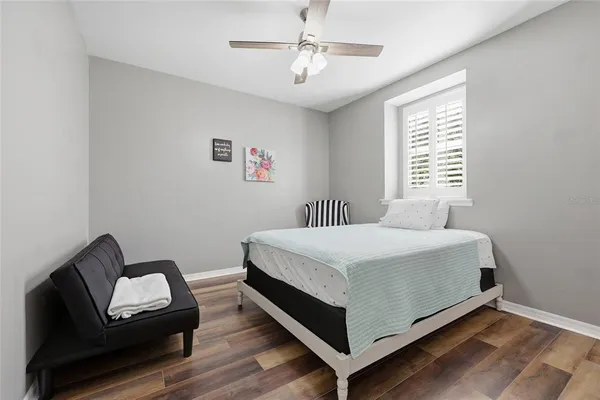 a bedroom with a bed chair and a window