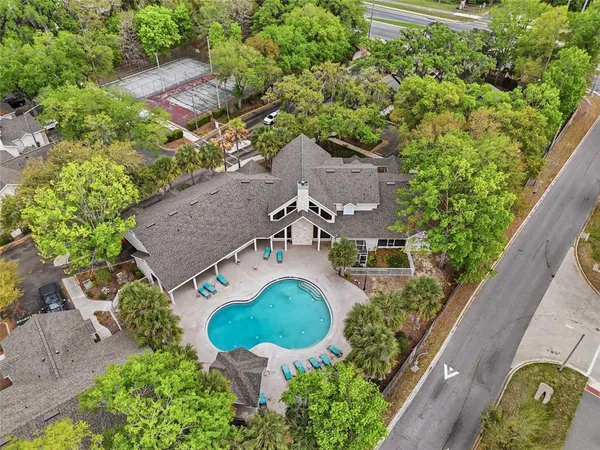 an aerial view of a house with yard swimming pool and outdoor seating