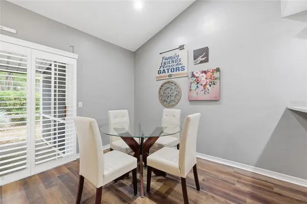 a view of a dining room with furniture and wooden floor