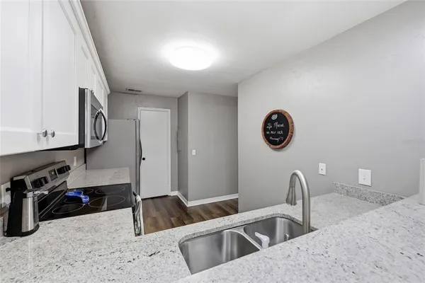 a kitchen with a refrigerator and a sink