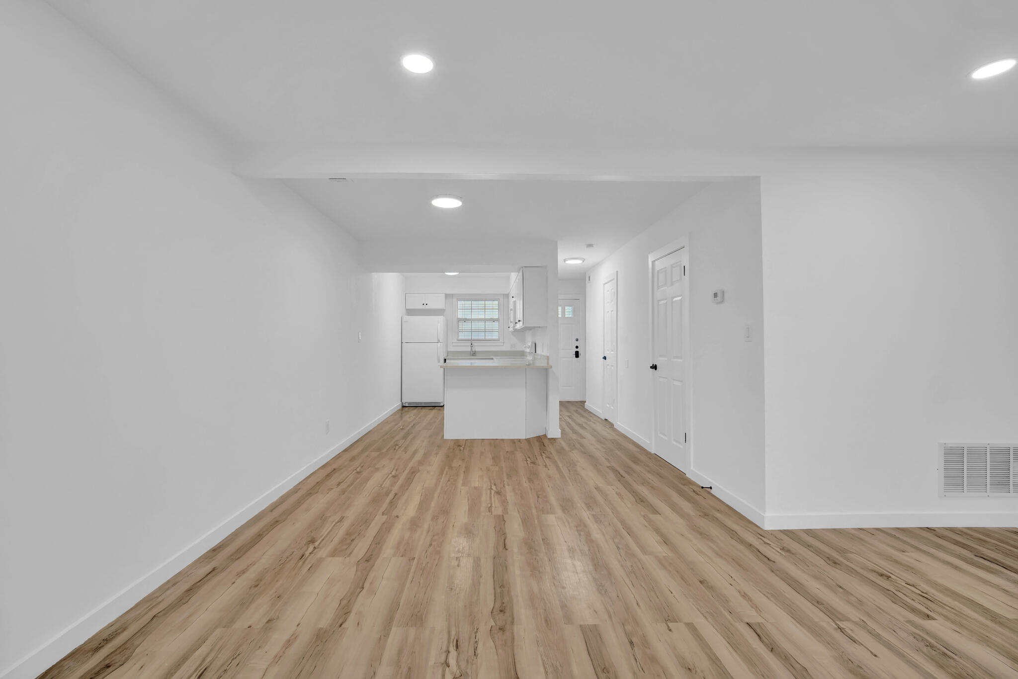 a view of a room with wooden floor