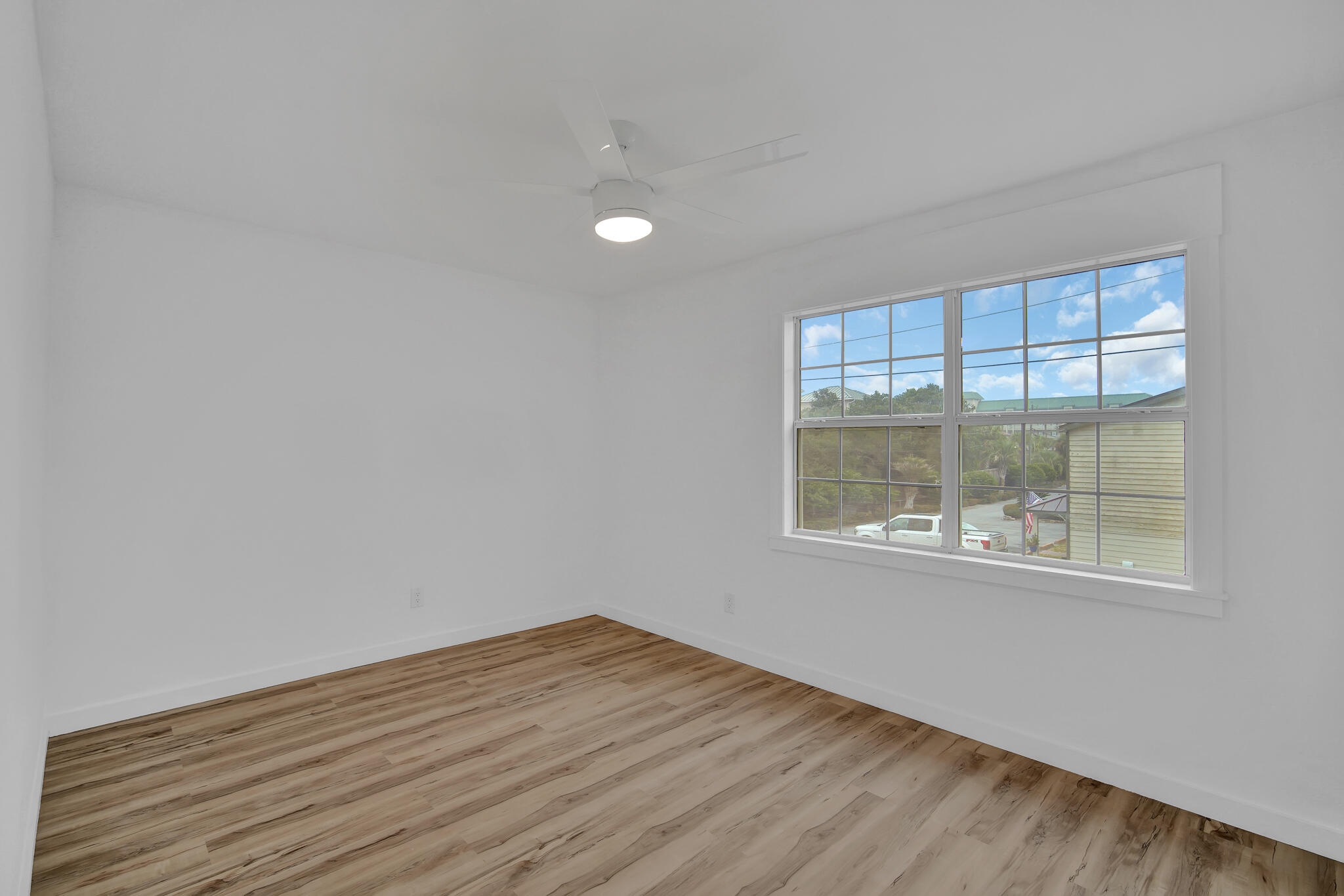 43 Summer Haven Trail, Unit 2 Miramar Beach, FL 32550 - Photo 17 of 22 an empty room with wooden floor and windows