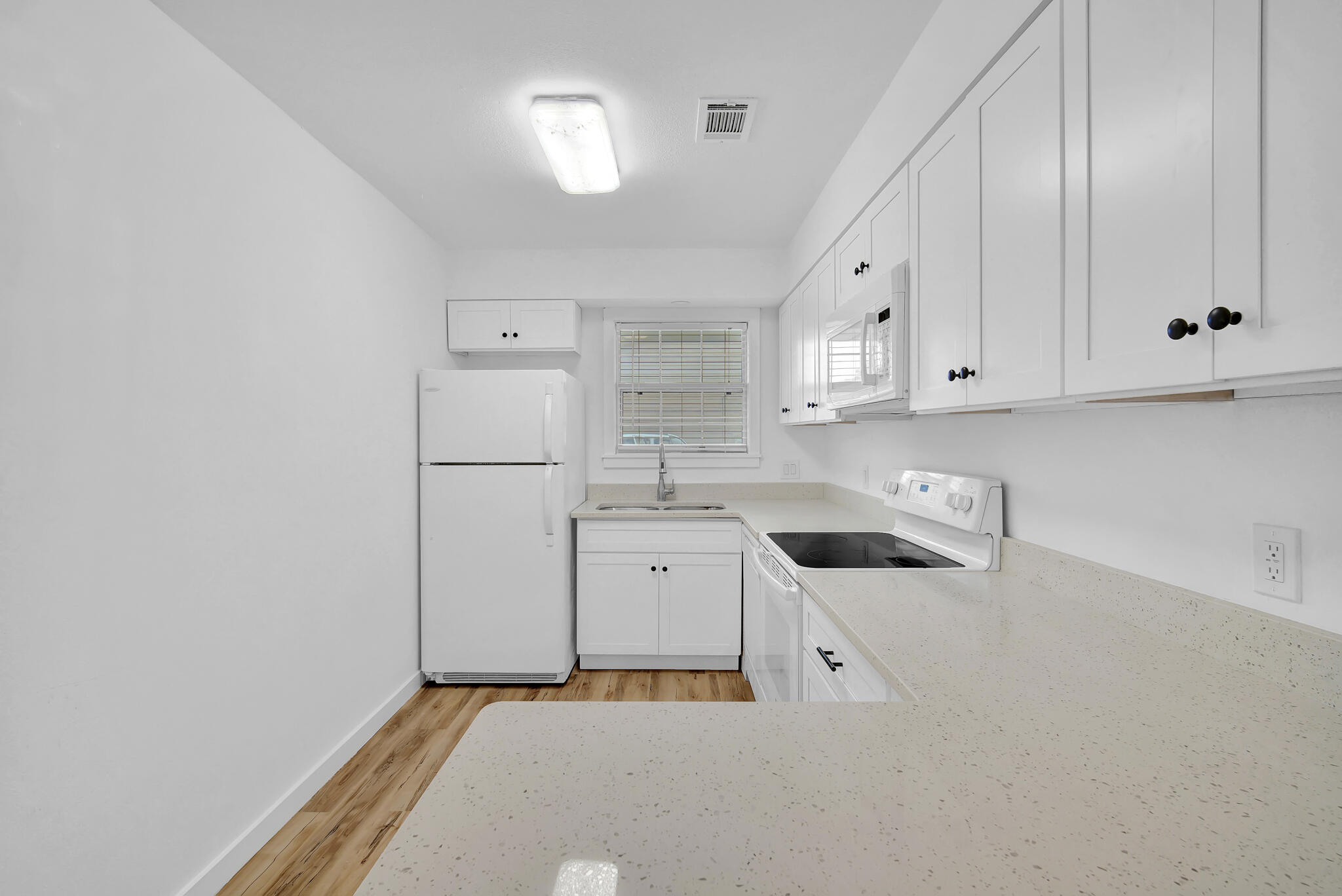 43 Summer Haven Trail, Unit 2 Miramar Beach, FL 32550 - Photo 9 of 22 a kitchen with white cabinets and white appliances