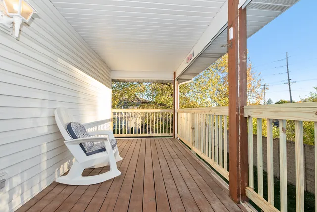 a view of a two chairs in the balcony