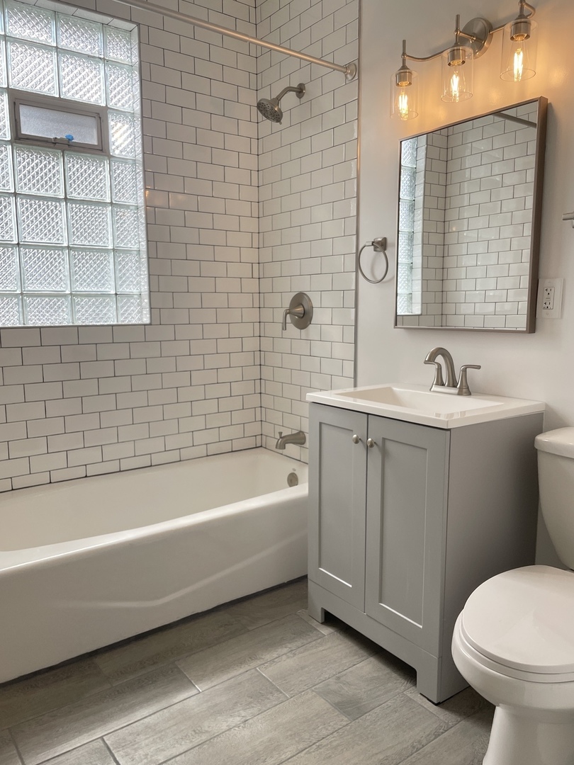 2416 North Springfield Avenue, Unit 2 Chicago, IL 60647 - Photo 8 of 9 a bathroom with a sink a toilet and shower