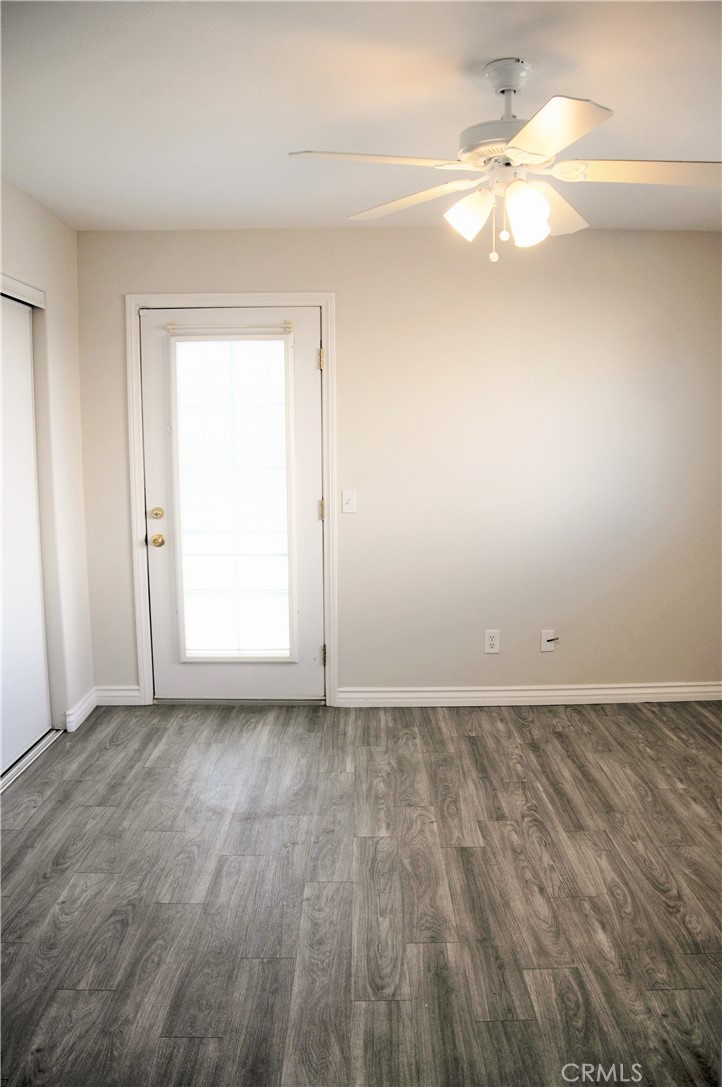 15354 Kiamichi Road Apple Valley, CA 92307 - Photo 11 of 22 an empty room with wooden floor and windows
