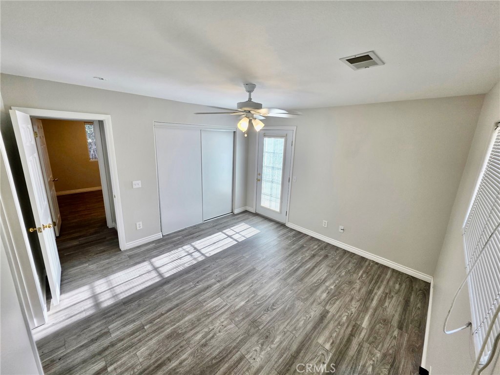 15354 Kiamichi Road Apple Valley, CA 92307 - Photo 13 of 22 wooden floor in an empty room with a window