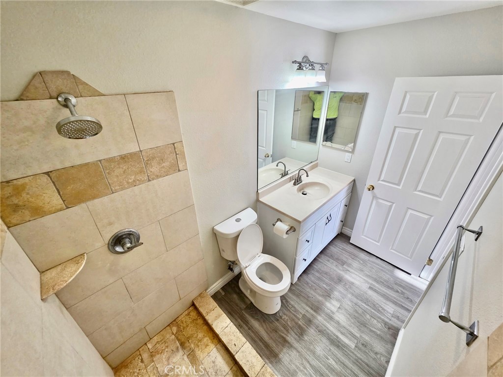 15354 Kiamichi Road Apple Valley, CA 92307 - Photo 14 of 22 a bathroom with a toilet sink and mirror