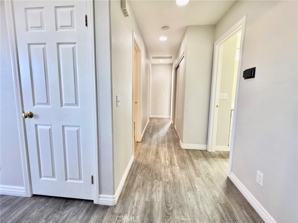 15354 Kiamichi Road Apple Valley, CA 92307 - Photo 16 of 22 a view of a hallway with wooden floor and entryway
