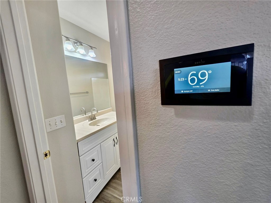 15354 Kiamichi Road Apple Valley, CA 92307 - Photo 17 of 22 a view of bathroom with mirror and door